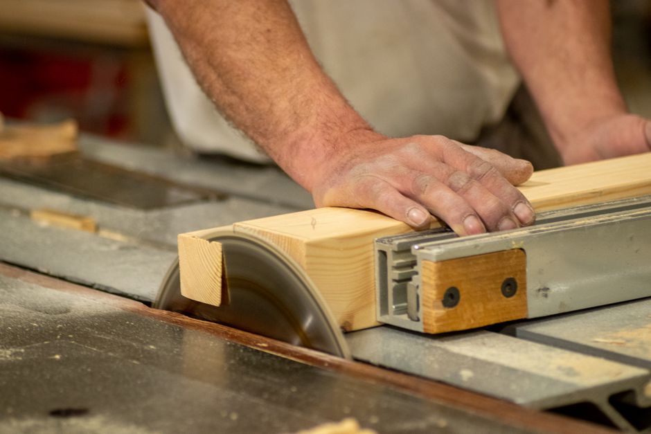 Skilled carpenter carefully assembling wooden cabinets in a workshop